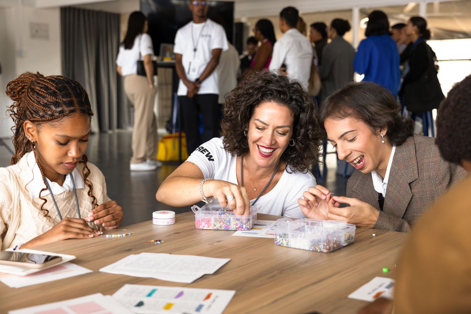 People participating in a group activity at tables during a workshop event.