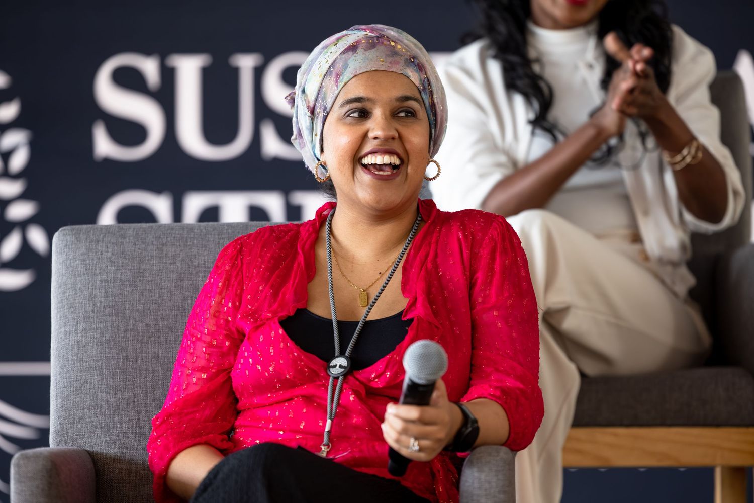 Speaker engaging with audience while presenting from a comfortable seating area.