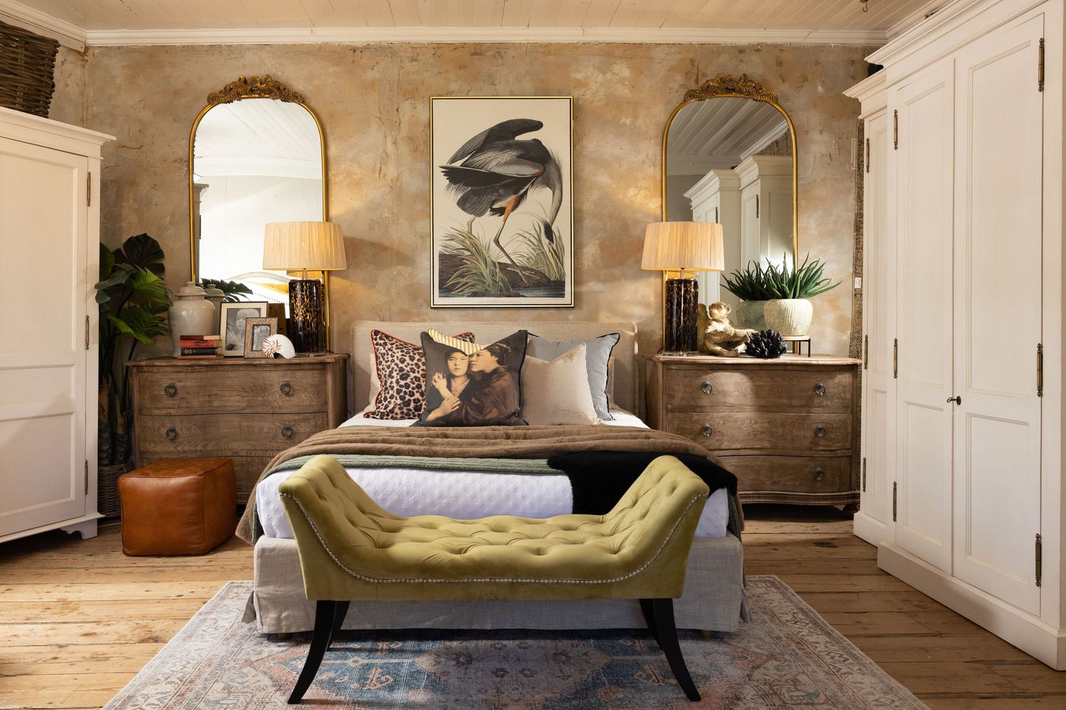 Modern bedroom with arched wall details, neutral tones, and vintage-inspired decor elements.