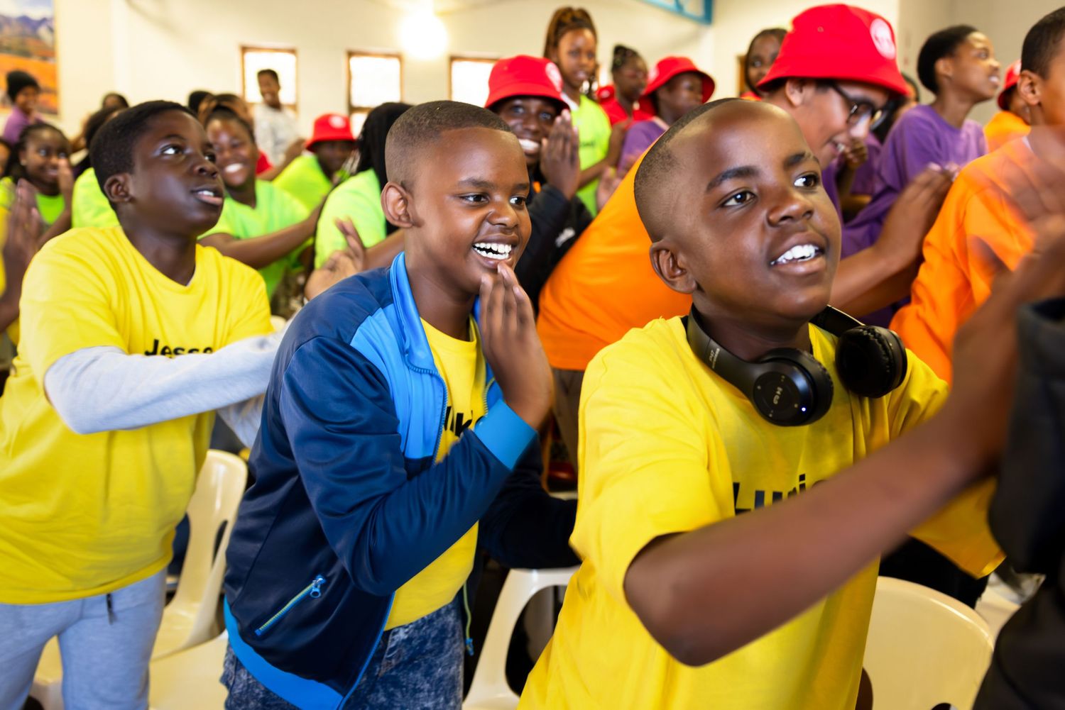 Group wearing colorful t-shirts engaged in energetic activity.