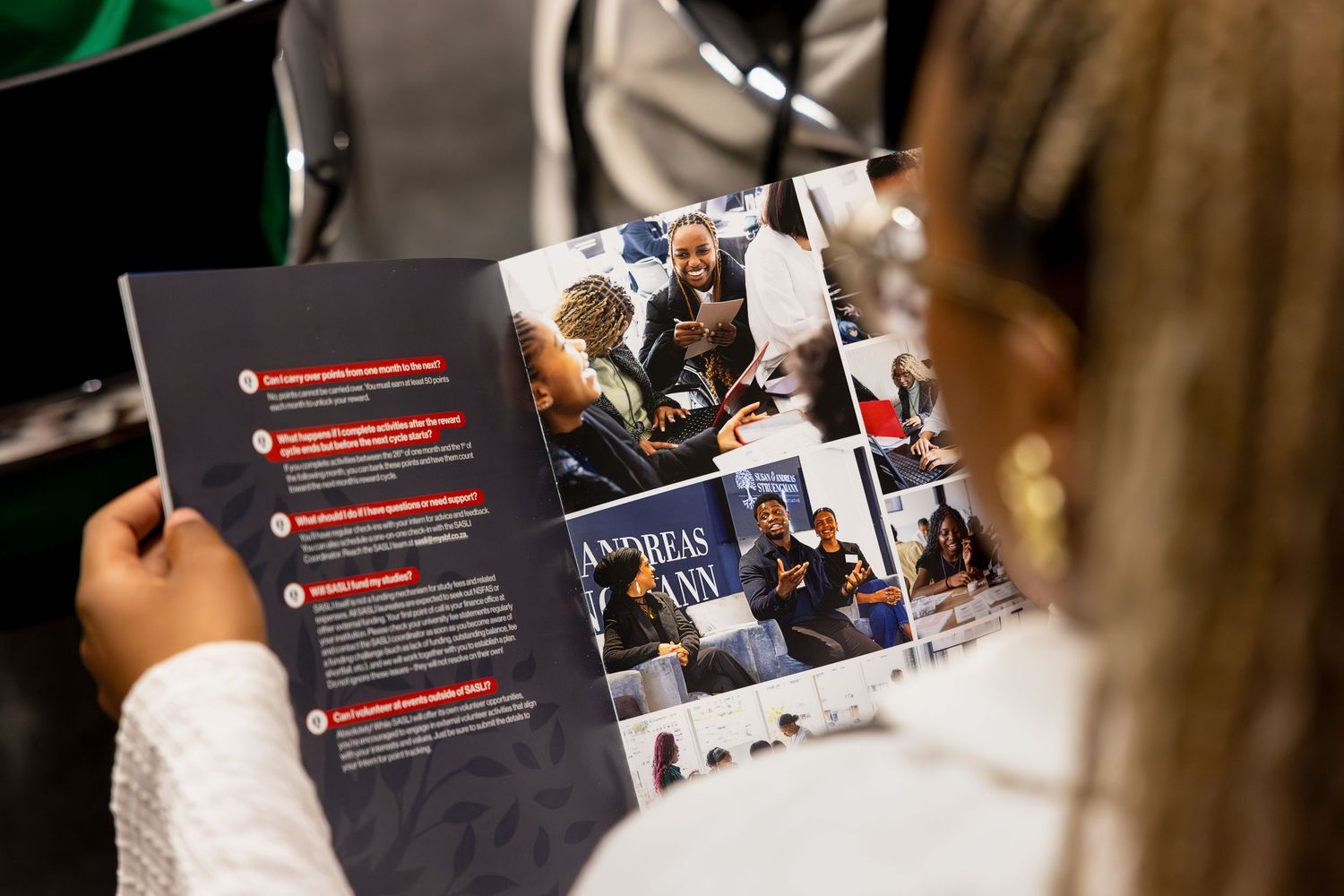 Conference attendees review program materials during a business event.