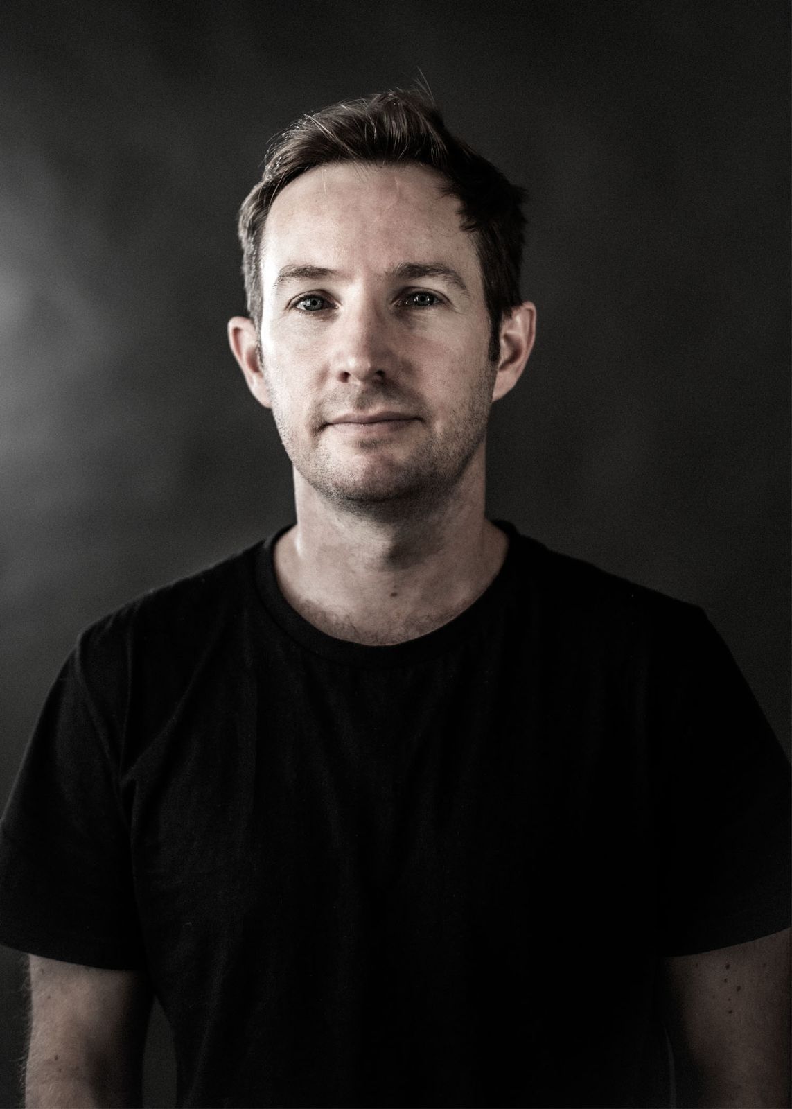 A dramatic black and white portrait series showing different angles and expressions against a dark background.