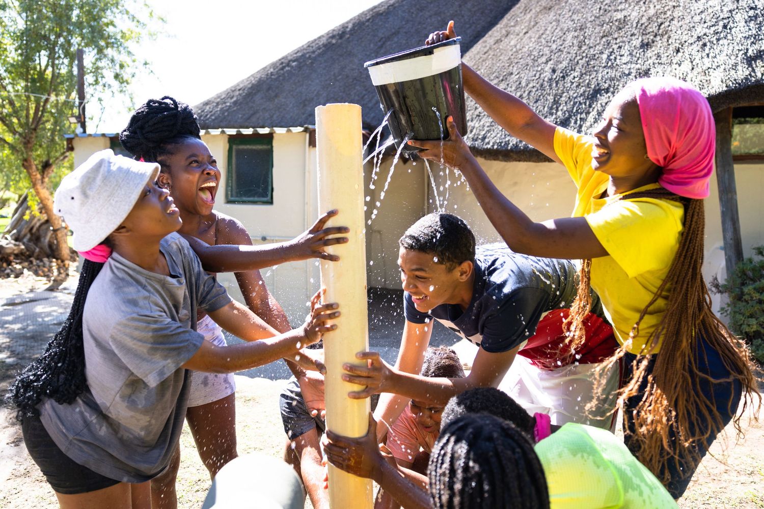 People playing interactive games and activities outdoors in a natural setting.