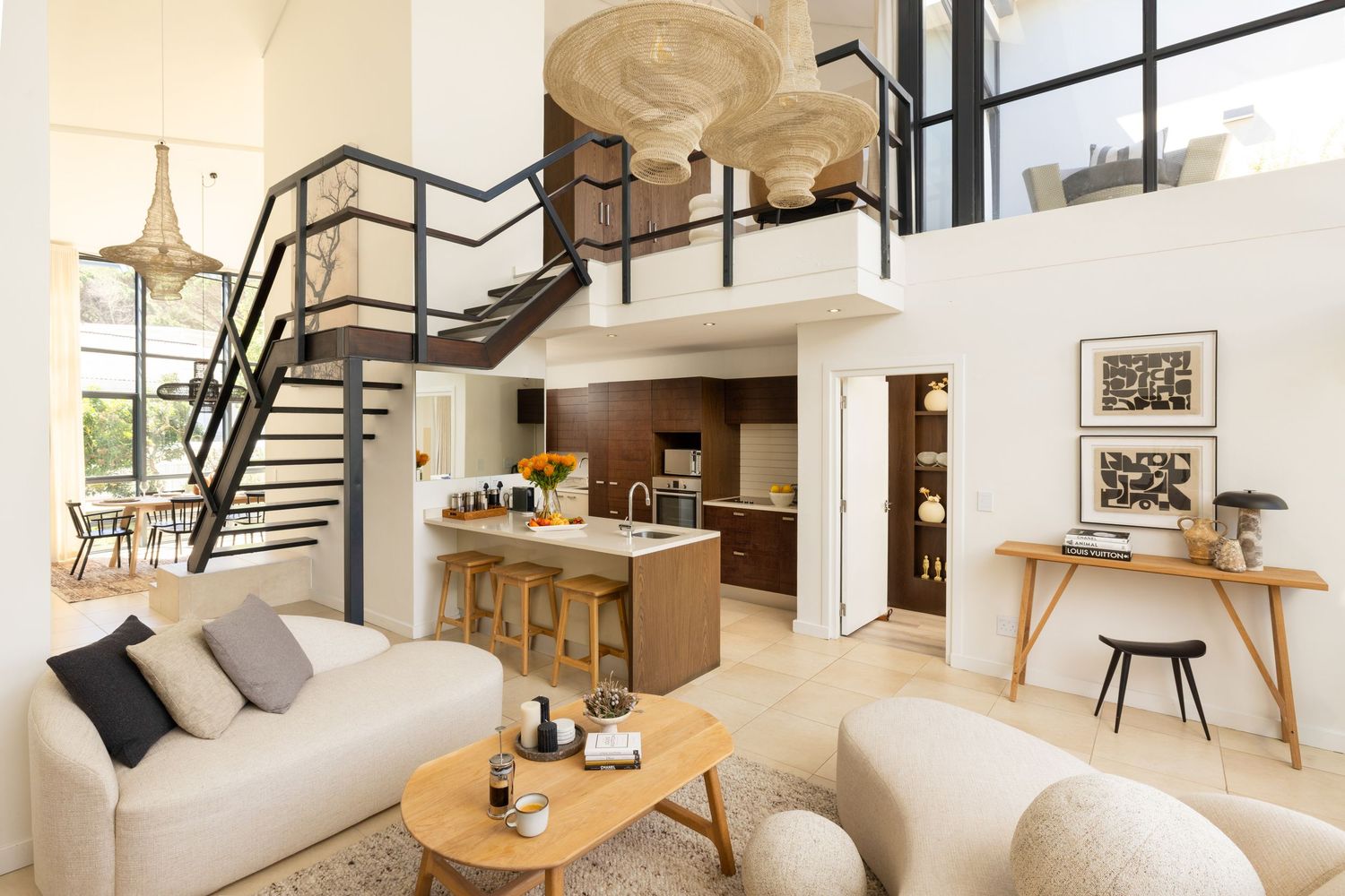 Sleek interior design featuring white walls, modern staircase, and open floor plan with natural light streaming through windows.