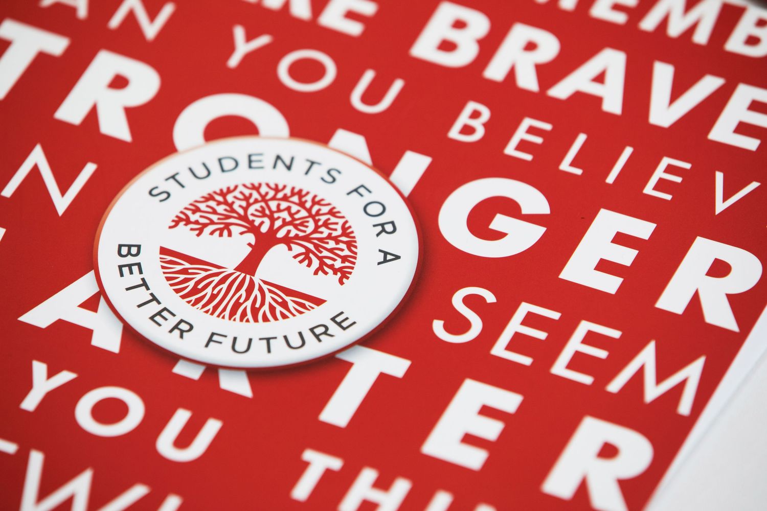 Red text and graphics printed on white promotional materials and banners.