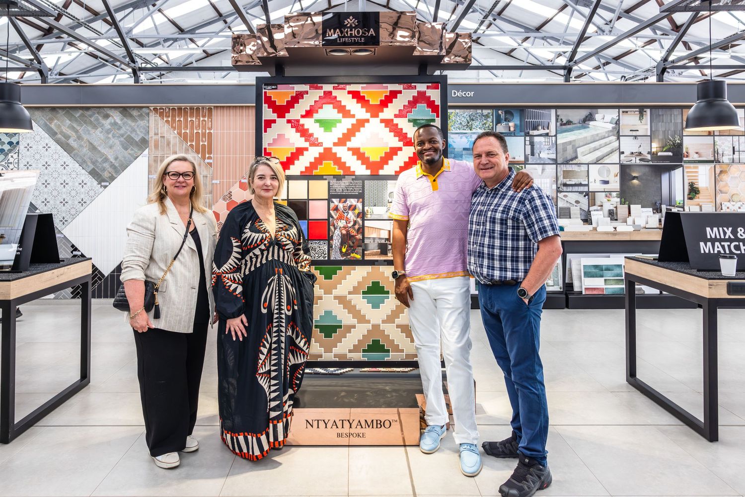 Modern tile showroom display featuring geometric pattern designs and colorful sample boards.