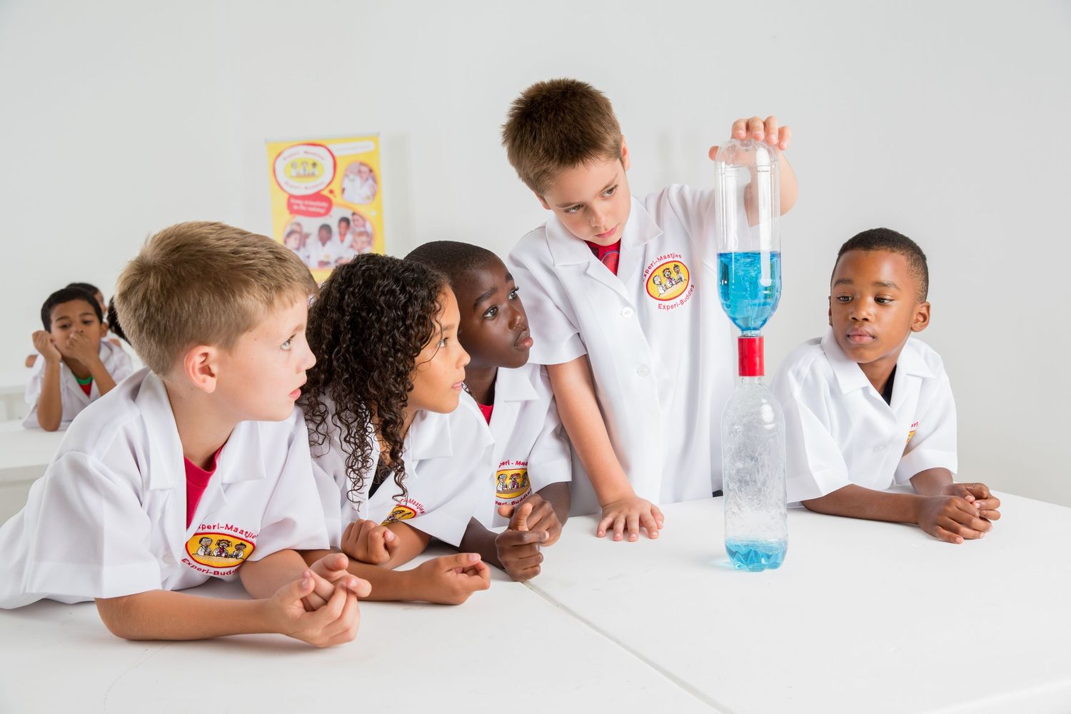 Students watch with excitement as blue liquid demonstration occurs in science class.