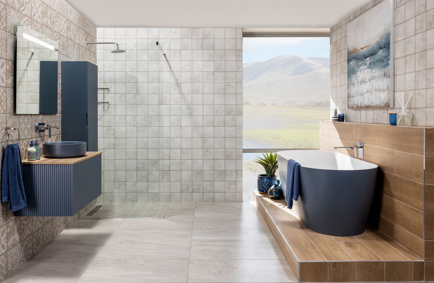 Luxurious bathroom featuring blue vanity, freestanding tub, and wood accents with mountain views.