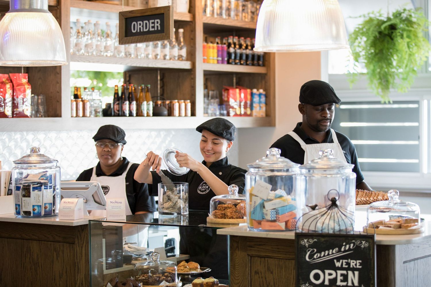 Interior view of The Block Cafe showing counter service and staff at work.
