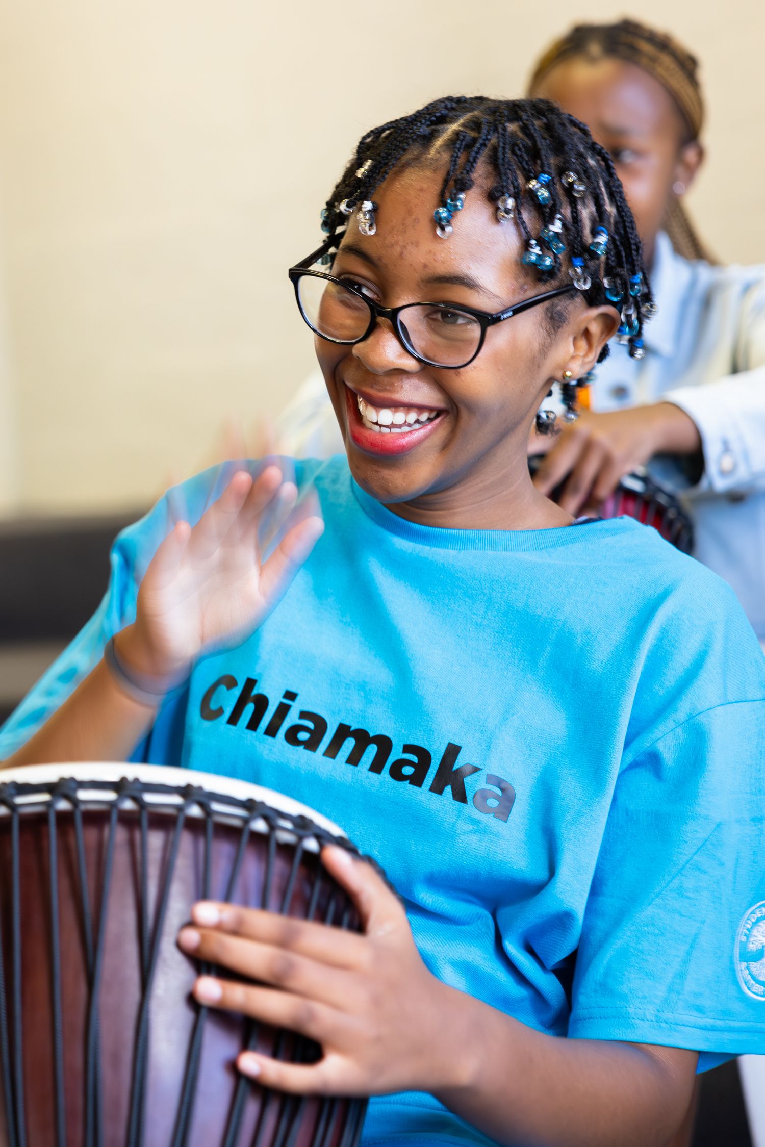 Student wearing bright blue t-shirt participating in engaging educational activity.