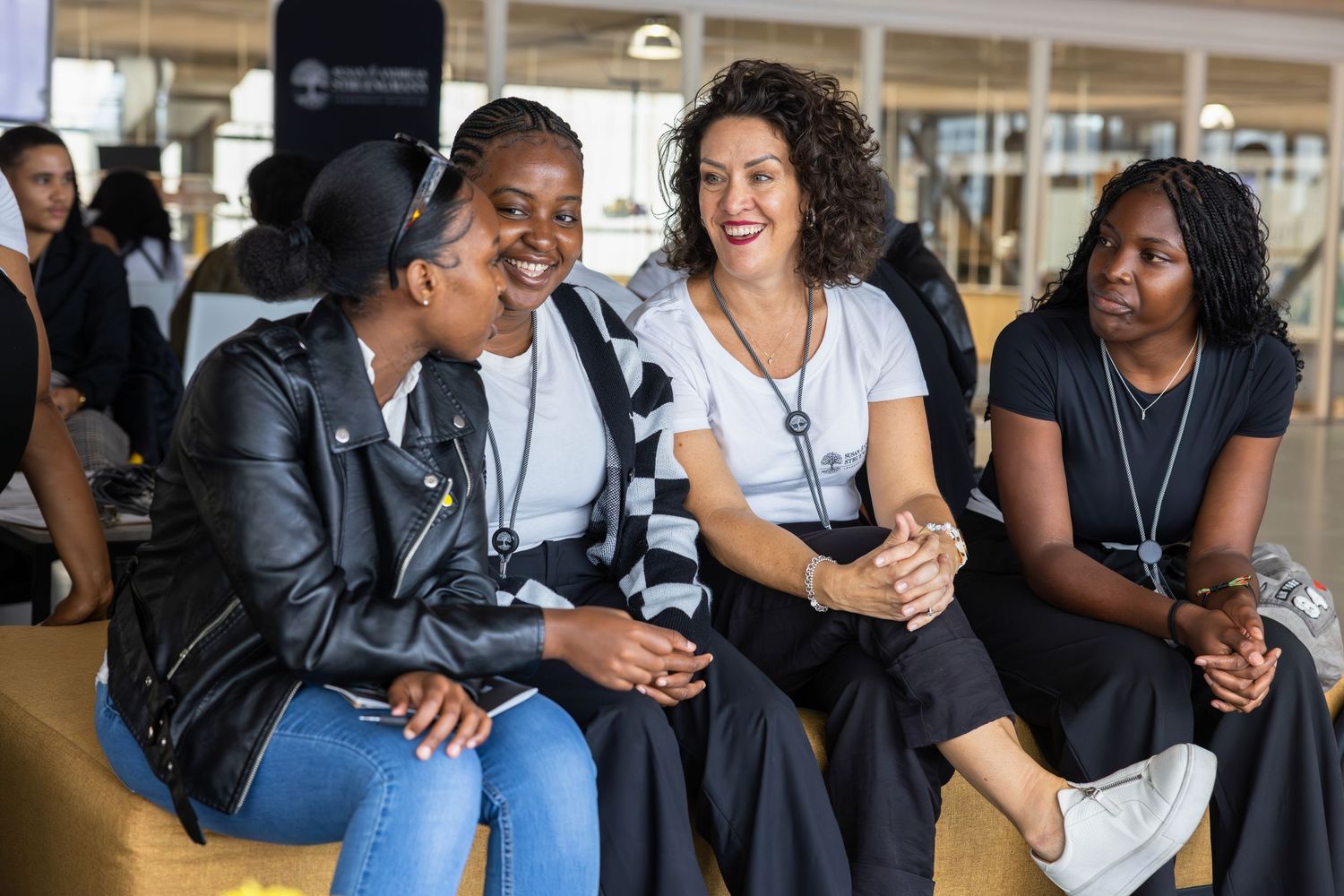 Group of attendees having animated discussions during a networking event.