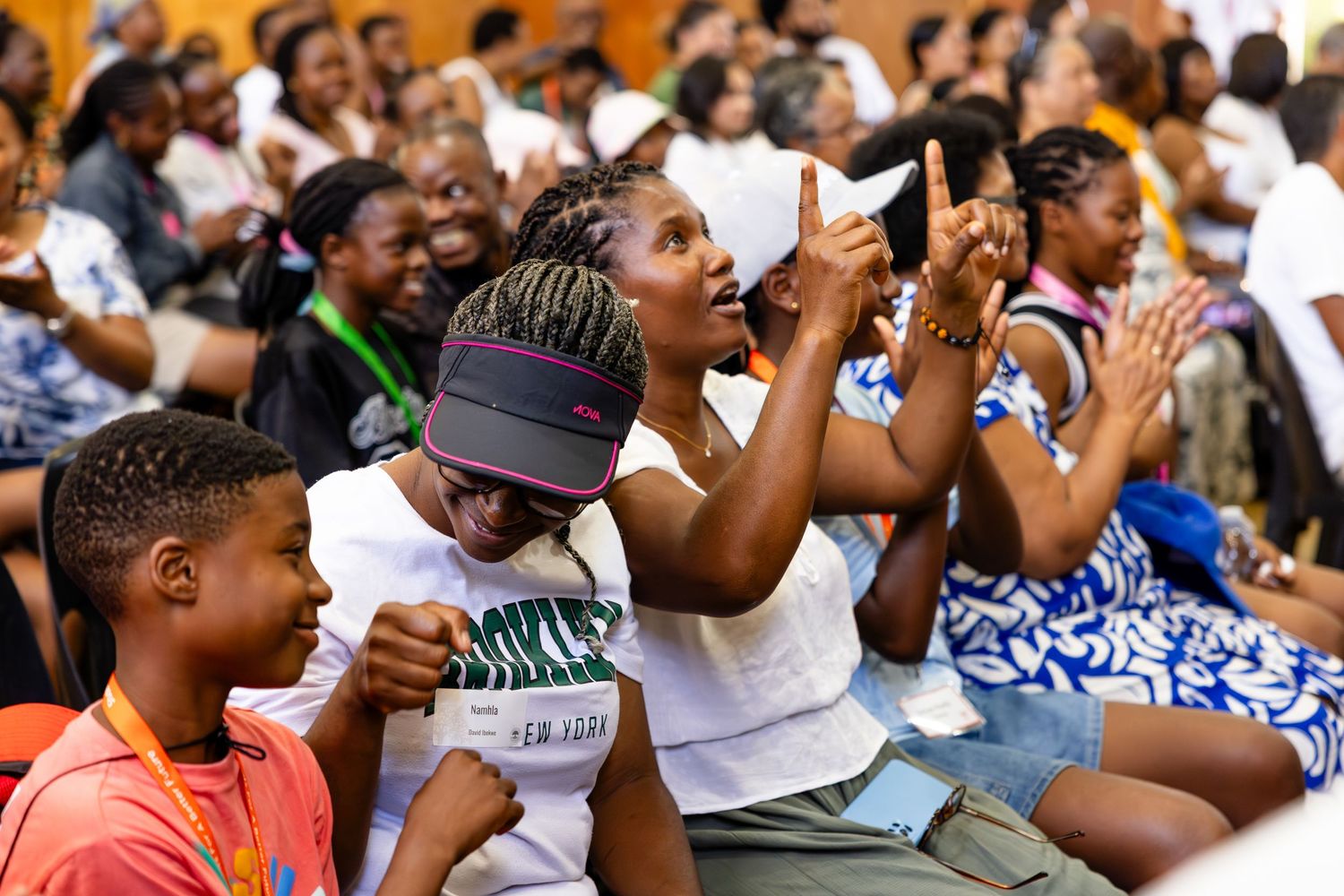 Audience members react enthusiastically during an engaging performance or presentation.