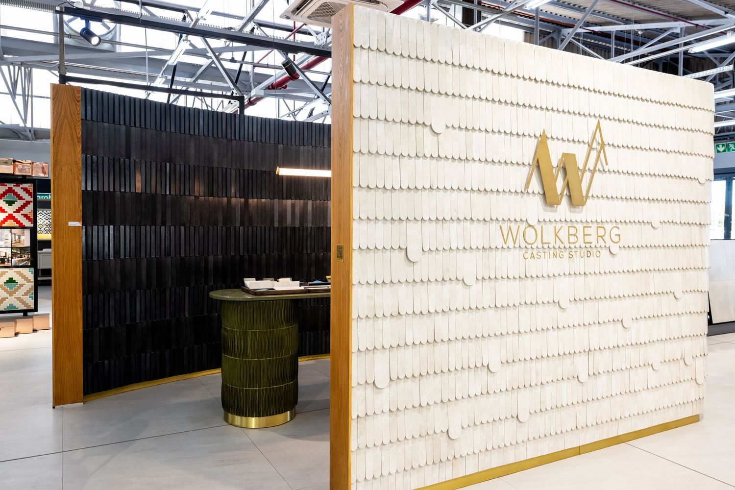 Contemporary office lobby featuring wood slat wall panels and minimalist branding elements.