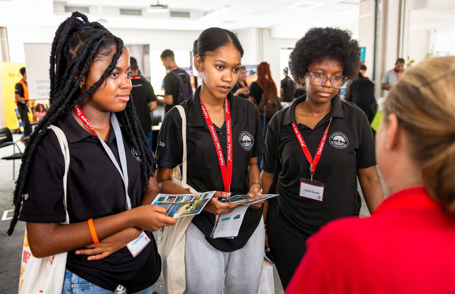 Diverse group of young professionals networking at a career development event.