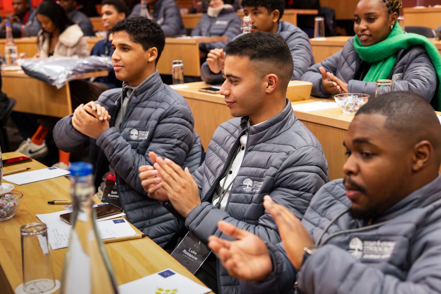 Attendees participate in an engaging workshop session while seated at conference tables.
