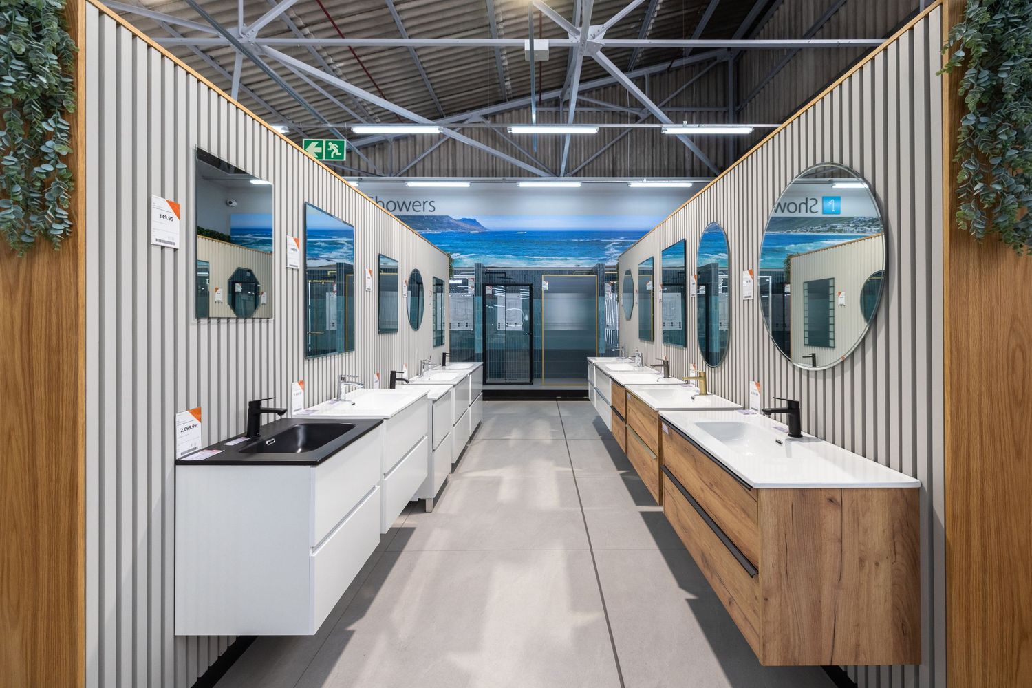Modern office interior with white walls, wood accents, and curved seating areas creating an open collaborative workspace.