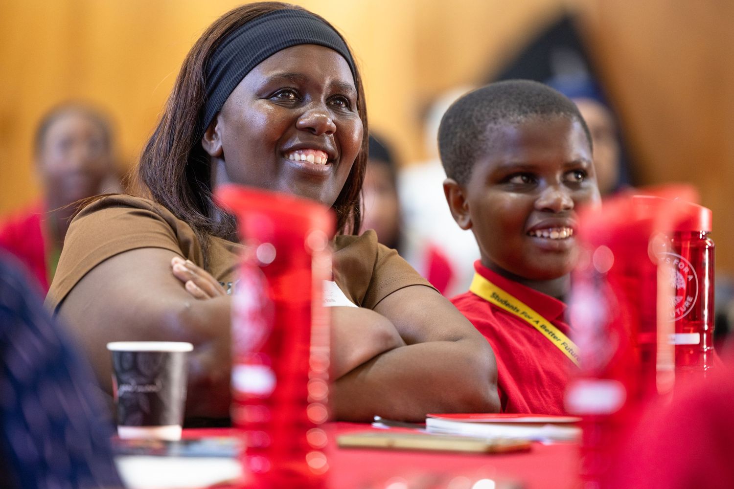 Students participating in an interactive classroom discussion wearing red shirts.