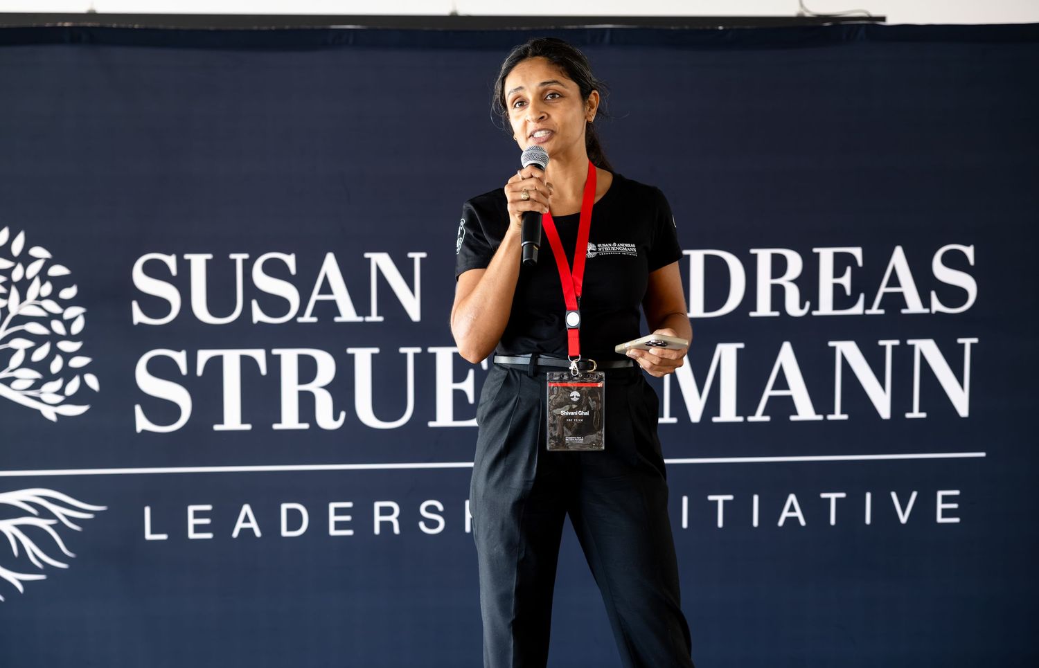 Professional conference banner display showing leadership initiative branding against dark background.
