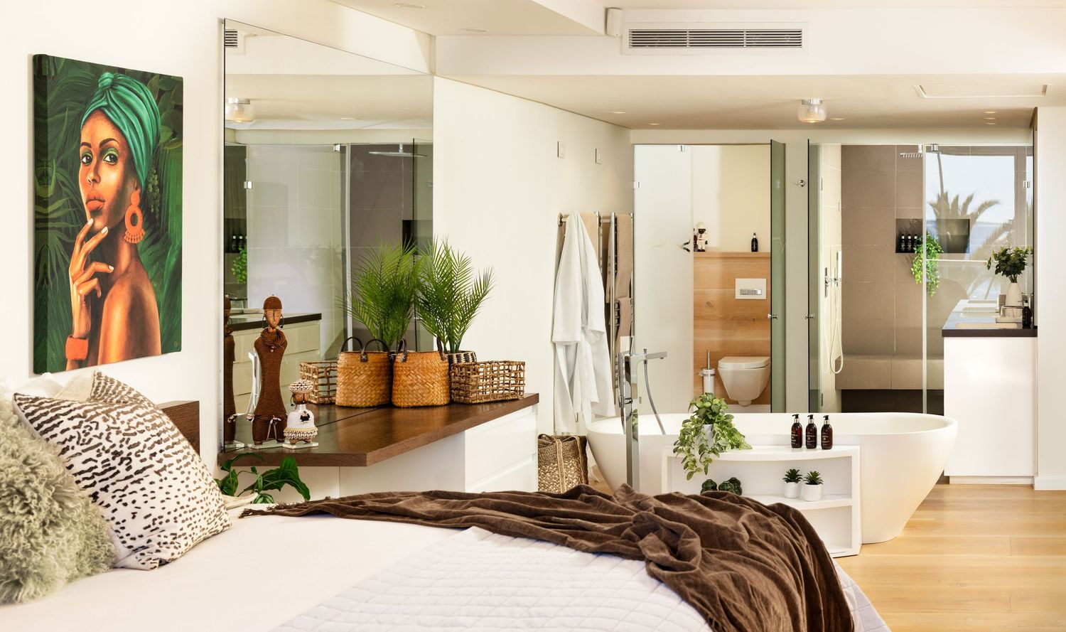 Modern apartment interior with white walls, wooden floors, and minimalist decor showing multiple connected rooms.
