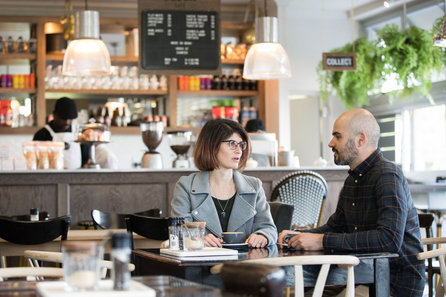 Casual dining area in a cafe with natural lighting and rustic decor.