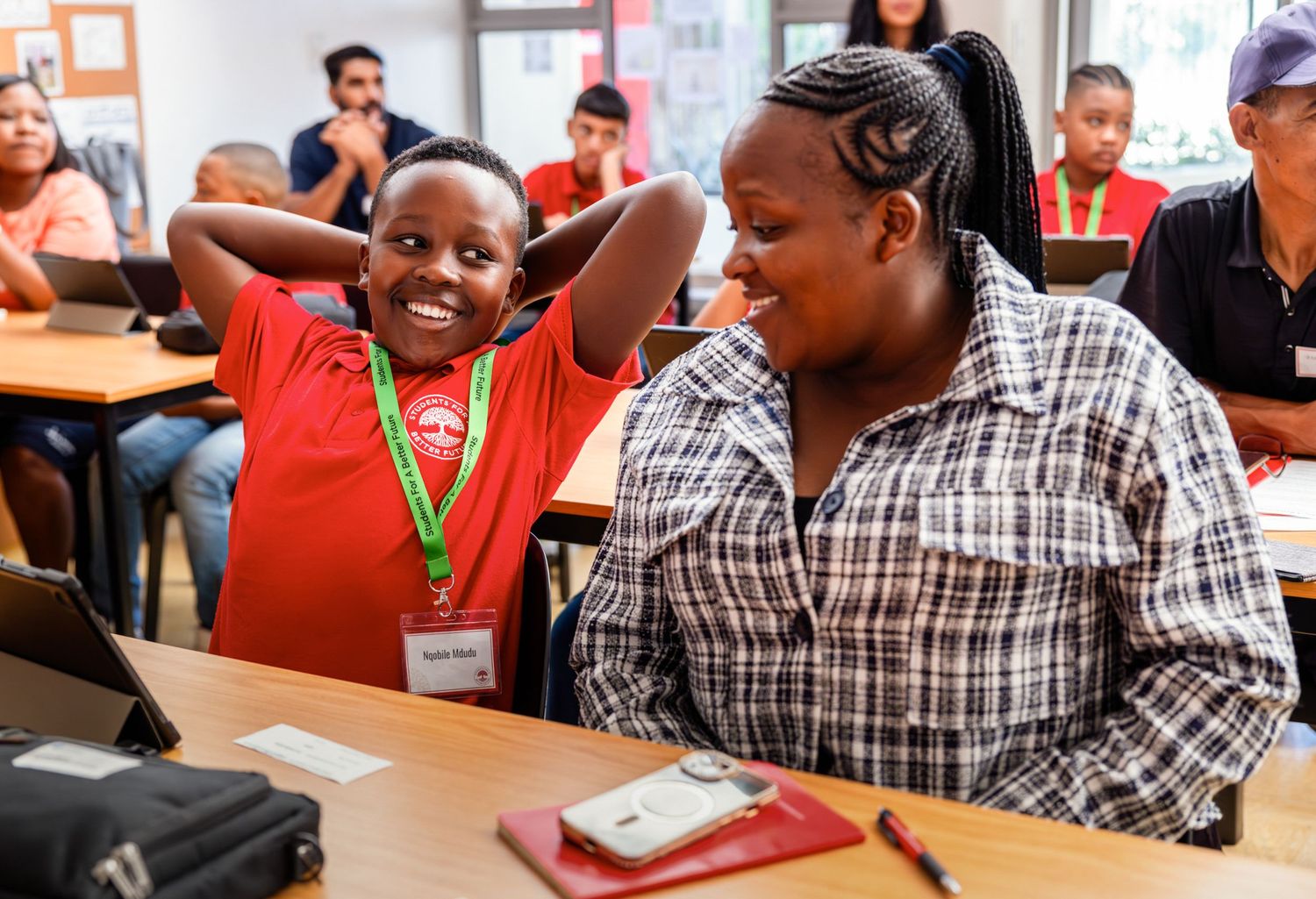Students share joyful moment during interactive learning session in classroom.