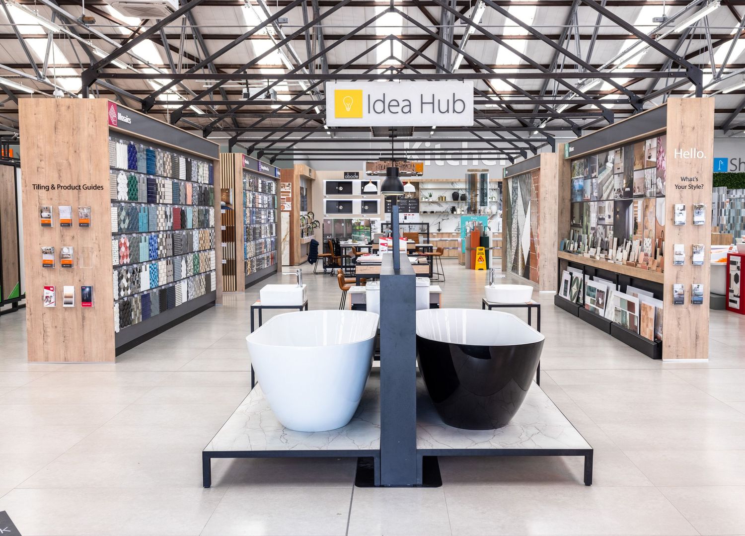 Interior view of modern retail space called Idea Hub with industrial ceiling.