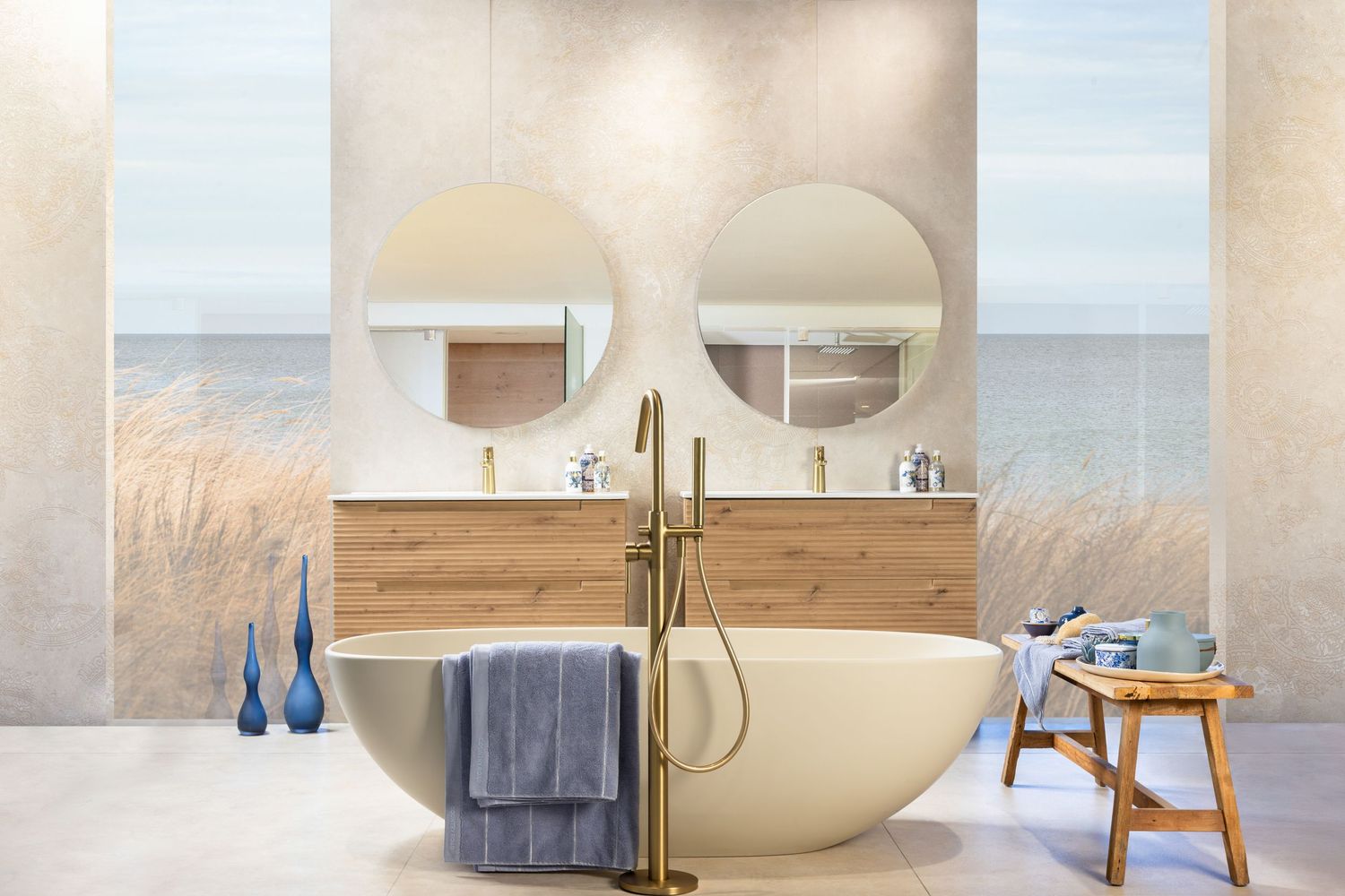 Modern luxury bathroom interior with freestanding bathtub, white decor, and natural lighting through large windows.