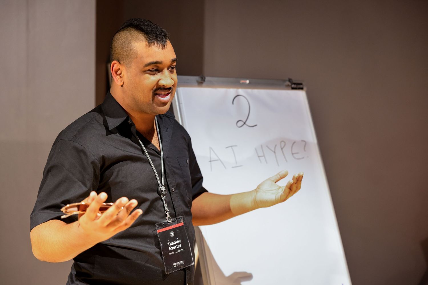 Attendees participate in an interactive workshop session with whiteboards and presentations.