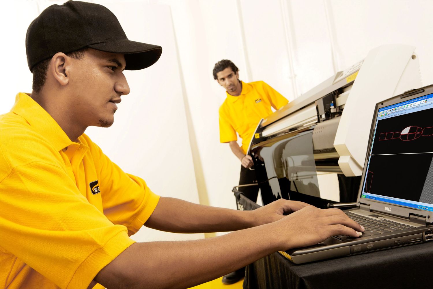 Automotive service staff working at computer terminals in repair facility.