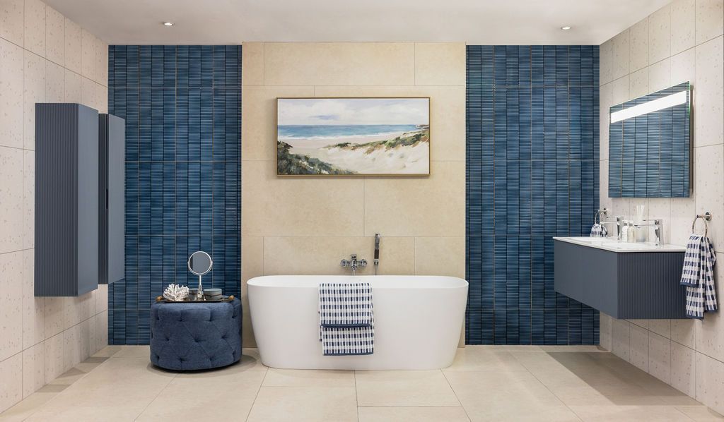 Modern bathroom interior with navy blue tile accent wall and beige tones featuring built-in storage and artwork.