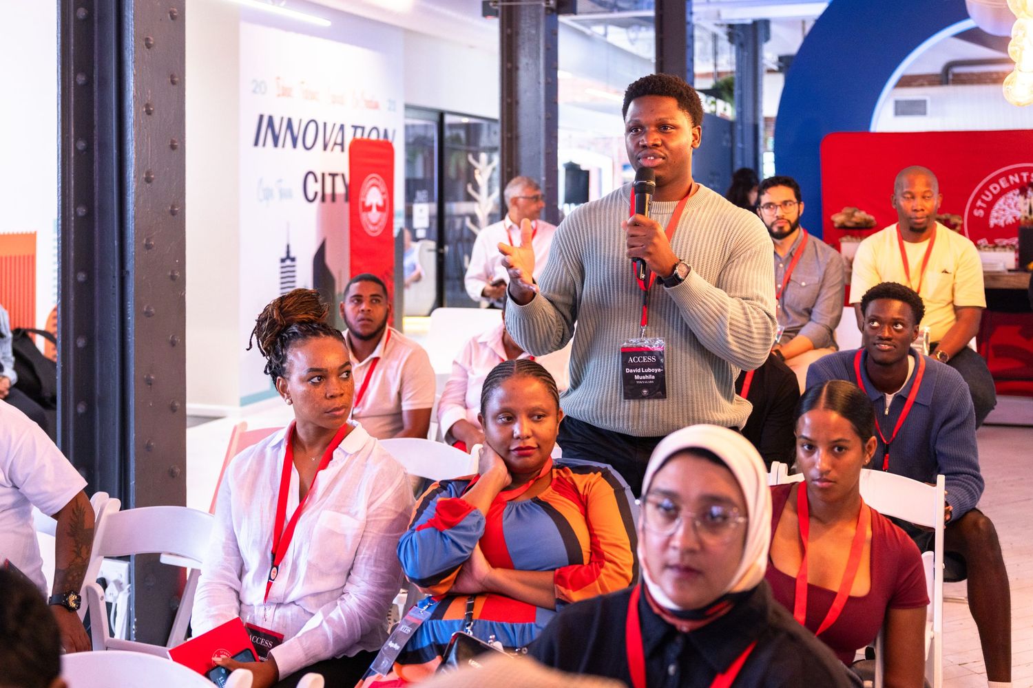 Conference participants engaging in group discussions at a business event.