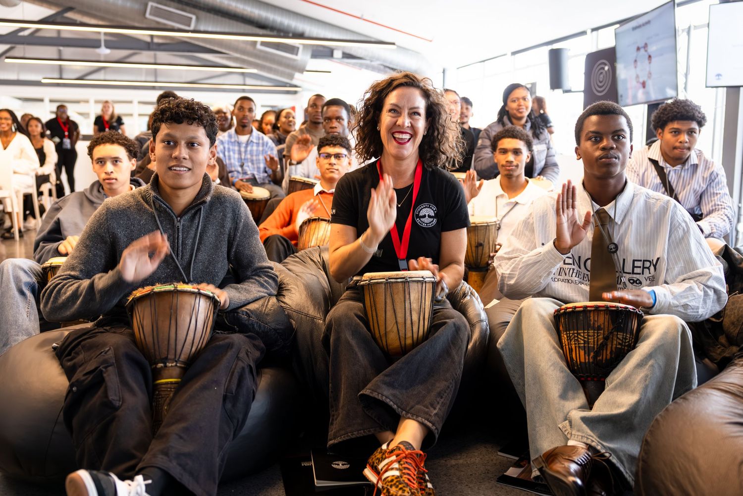 Large group of conference attendees participating in an interactive session in modern venue.