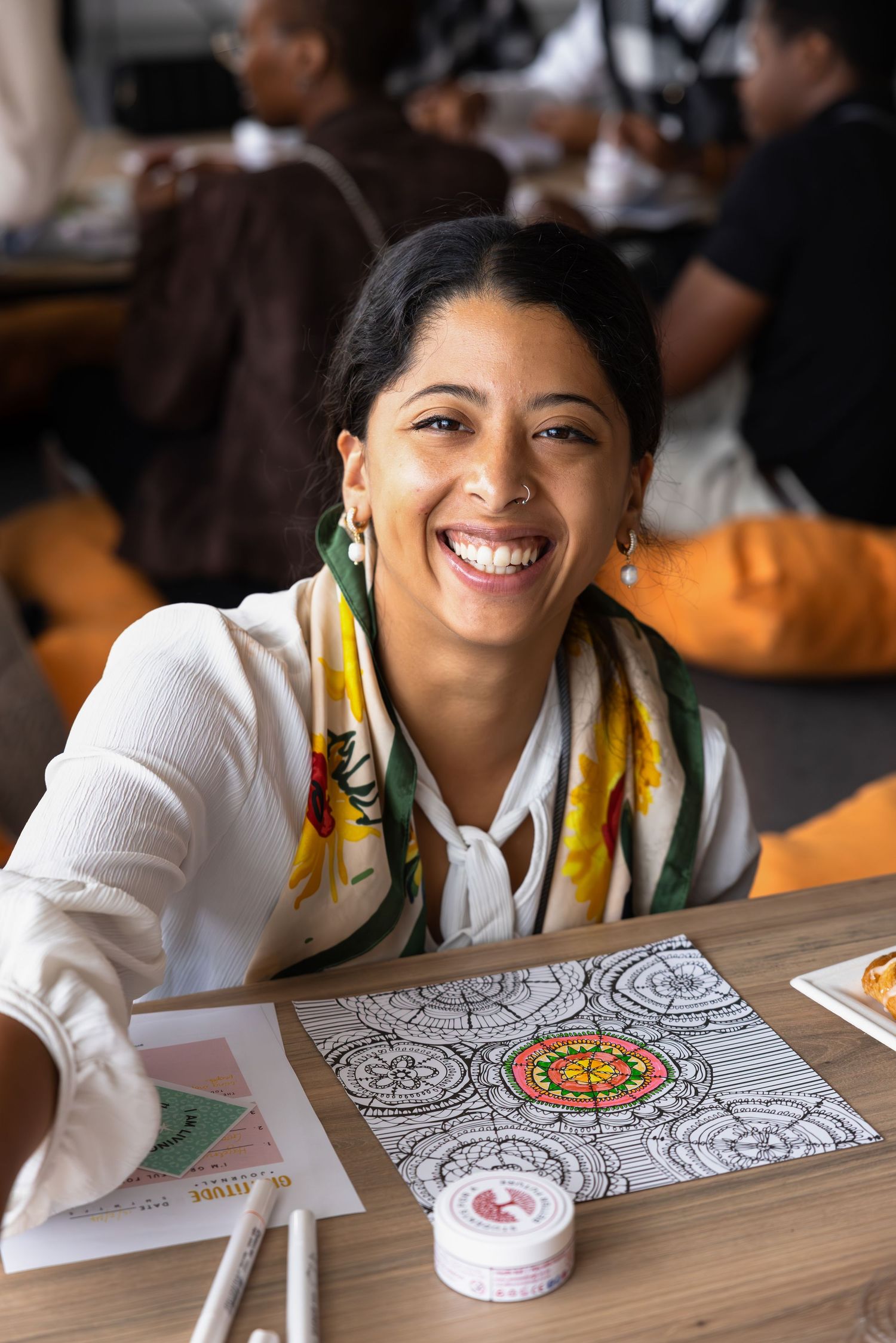Someone working on a colorful drawing activity at a desk.