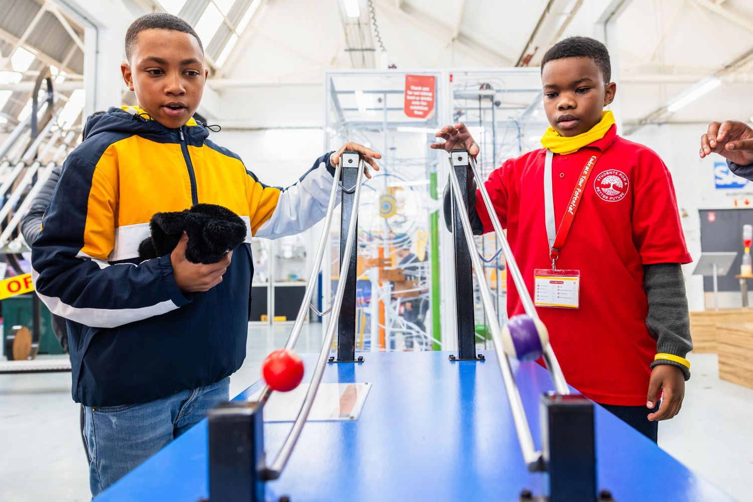 Students collaborate on science experiments at learning stations in a modern facility.