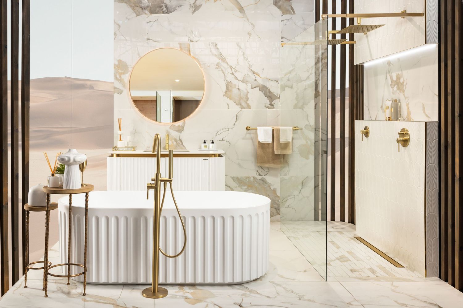 Luxurious marble bathroom featuring a freestanding tub, round mirror, and gold fixtures in an elegant setting.