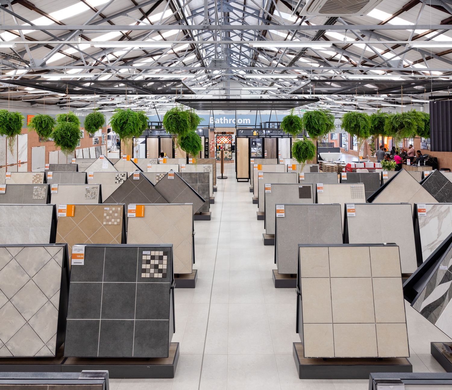 Large tile showroom floor with multiple display stations showing various flooring samples.