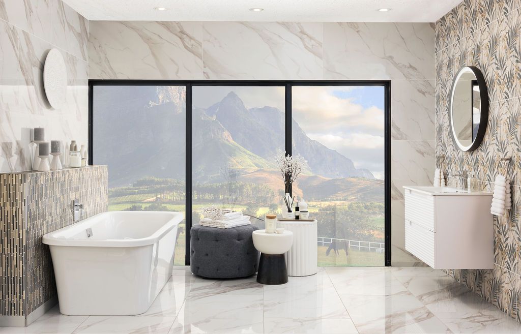 Luxurious modern bathroom design with marble walls, freestanding tub, and panoramic city views through floor-to-ceiling windows.