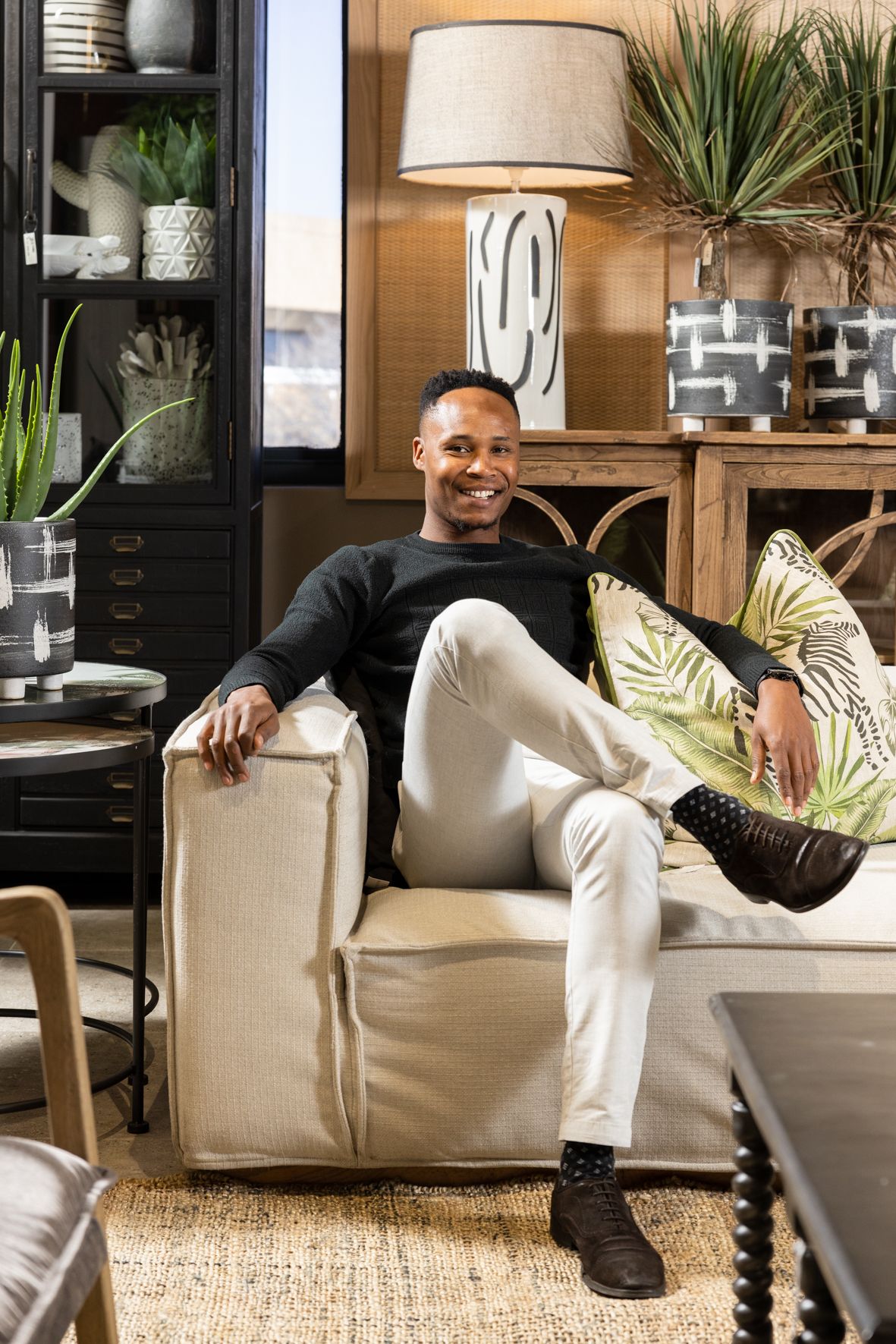 Modern living room vignette with botanical decor, natural textures, and comfortable seating.