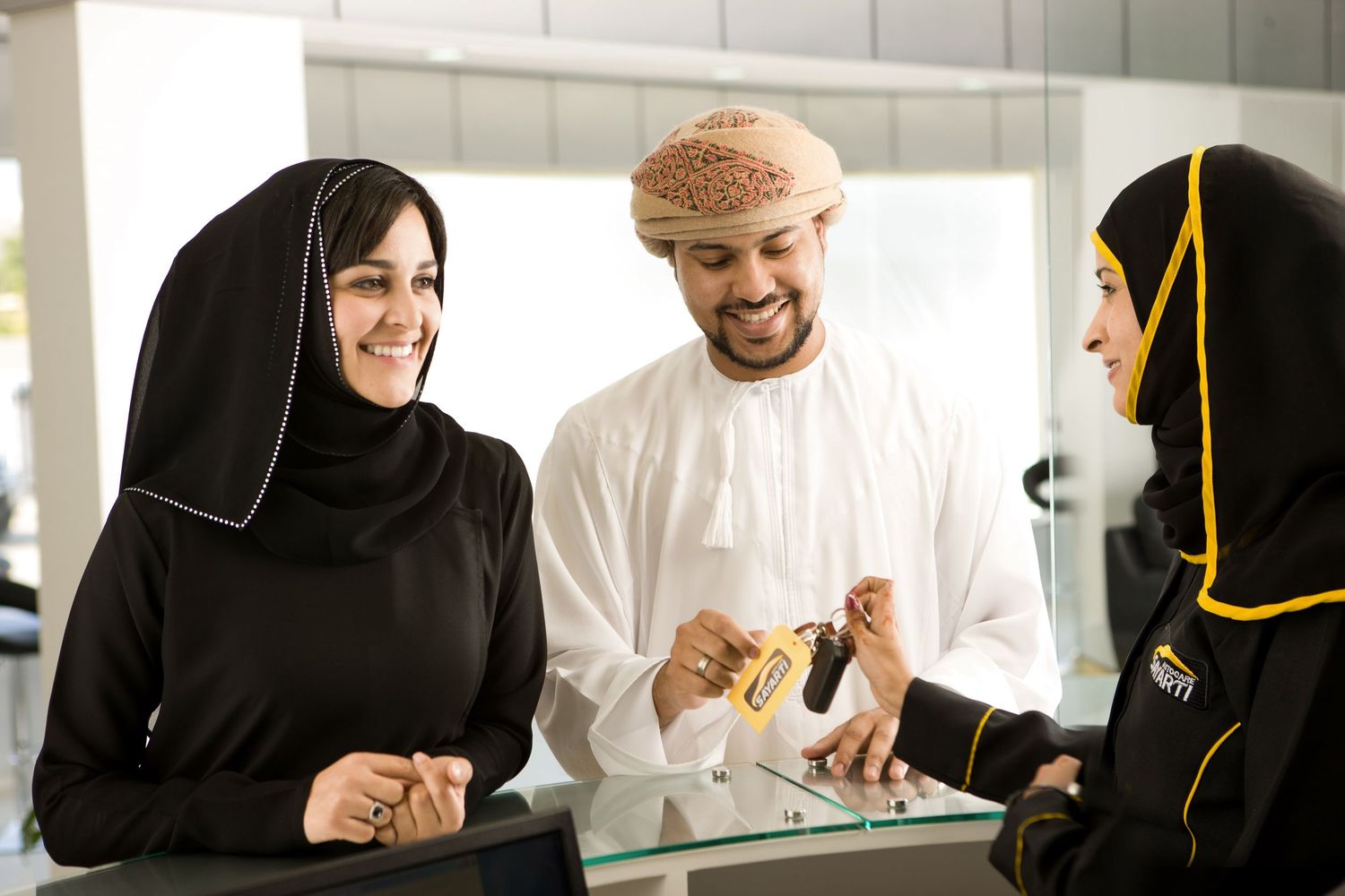 Customers discussing service options at automotive service counter.