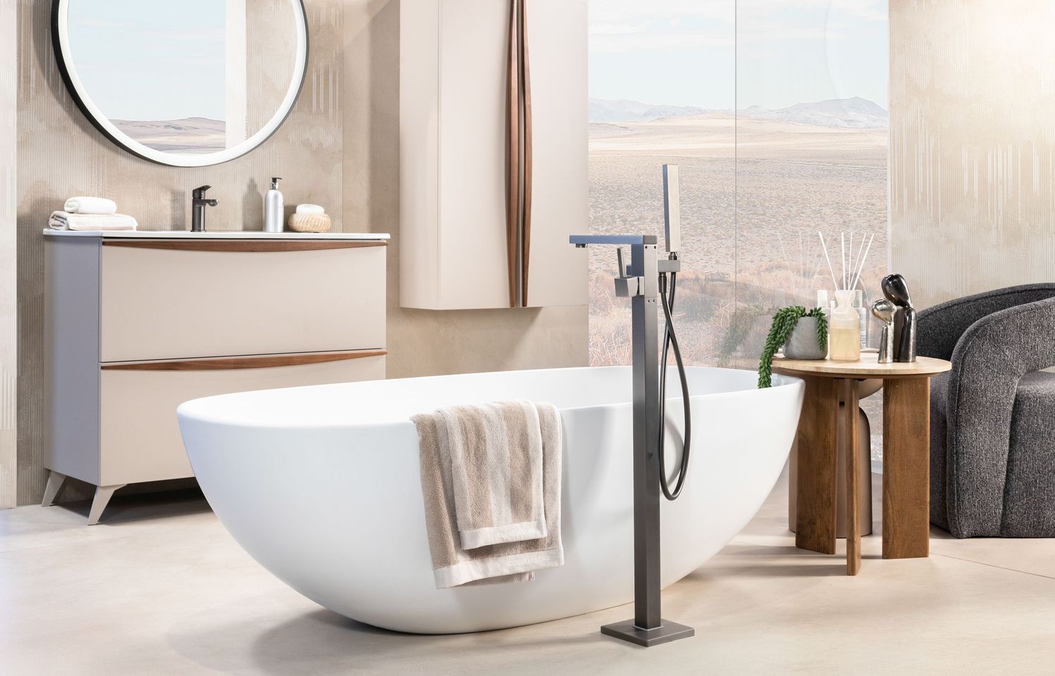 Modern freestanding white bathtub in a luxurious bathroom with gray vanity cabinet and floor-mounted tub filler.