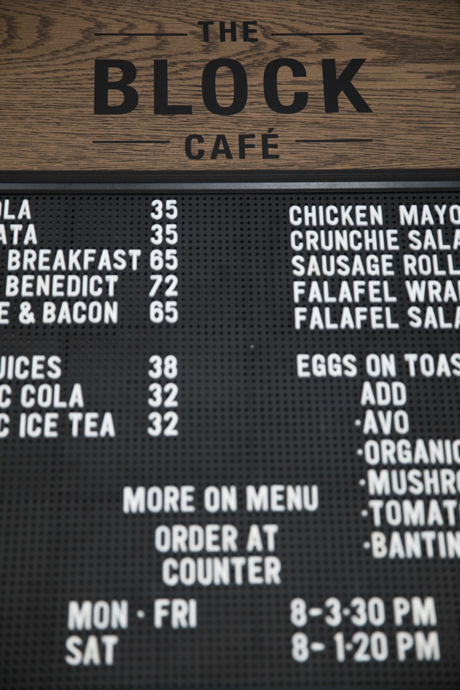 Menu board at The Block Cafe showing breakfast and lunch items with prices.