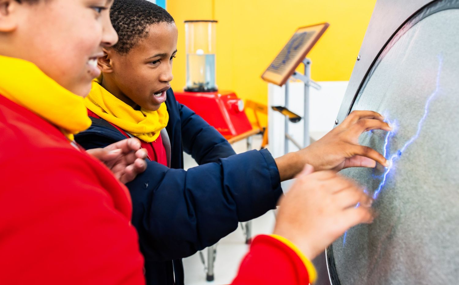 Young learners use tablets and digital tools for interactive science education activities.