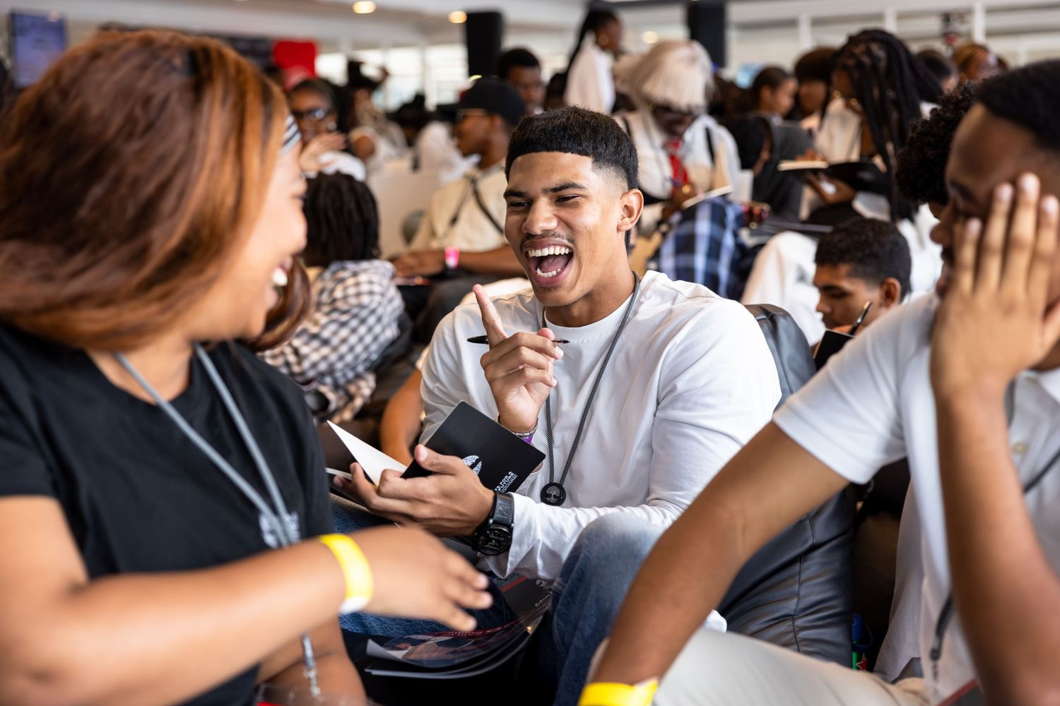 Diverse group of participants engage in animated discussion during a professional development event.