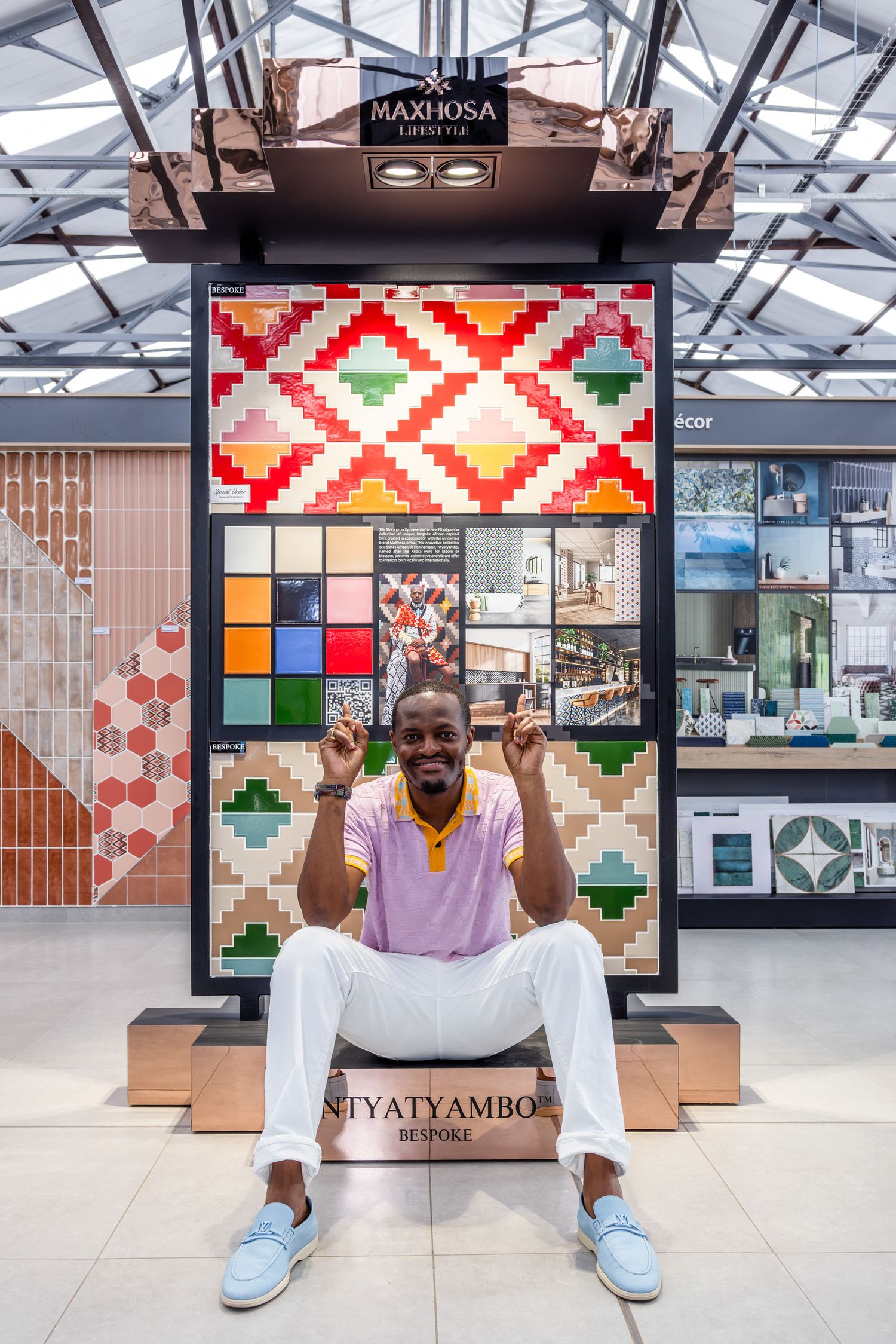 Colorful retail display featuring geometric patterns and vibrant tile samples in modern showroom setting.