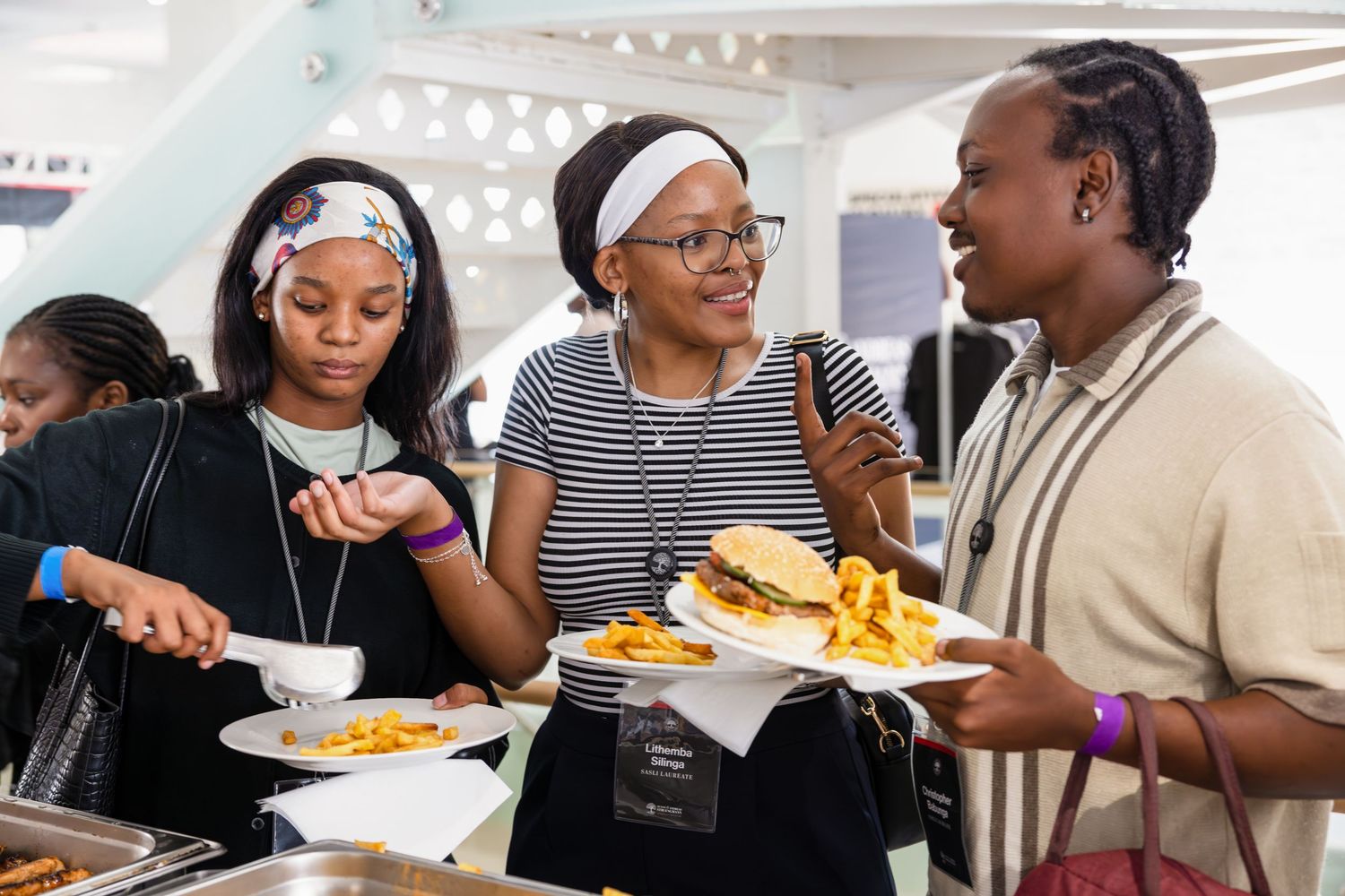 Friends enjoying a casual meal together at a cafeteria buffet line.