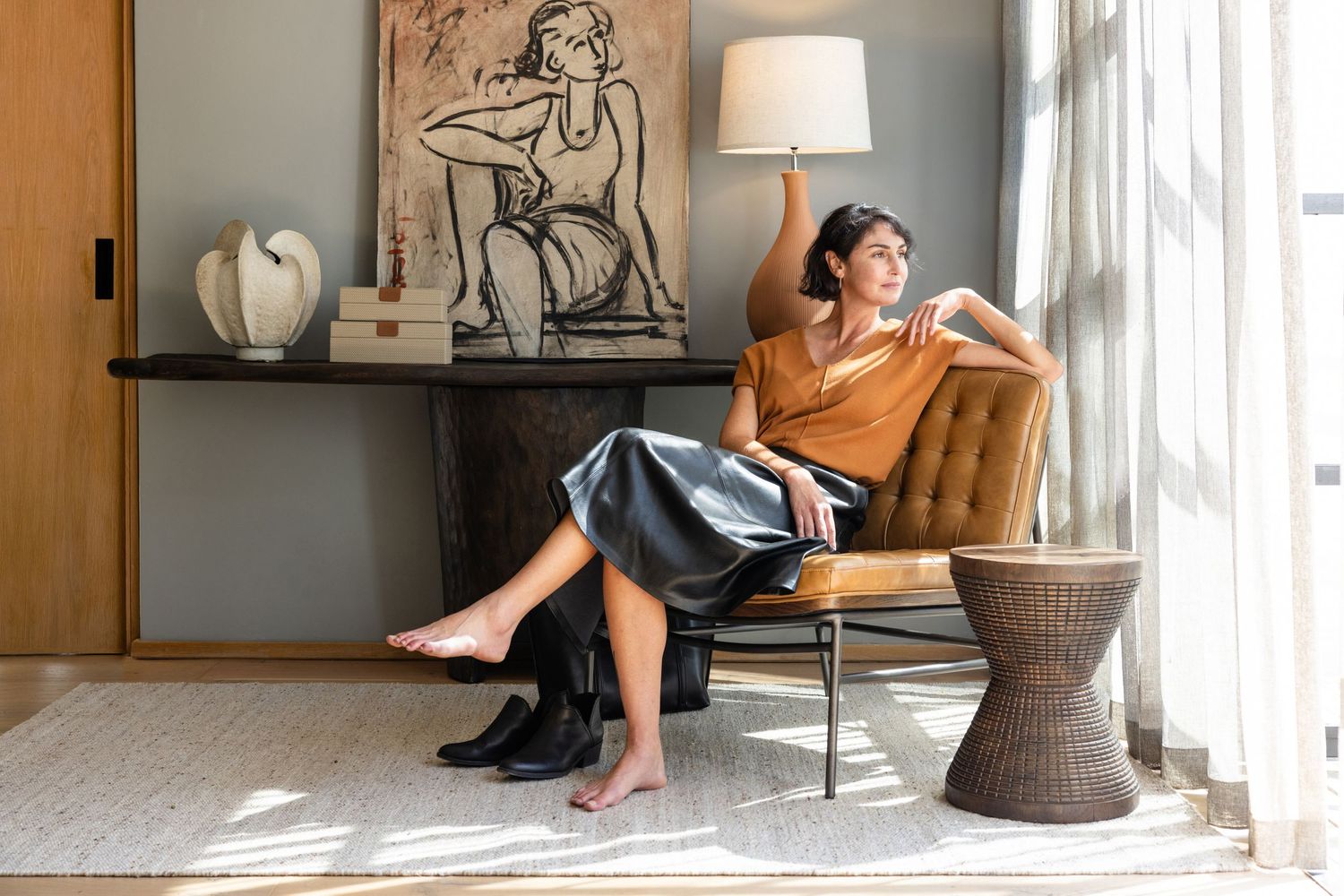 A sequence of photos shows a person lounging and working from home in various poses near large windows and modern decor.