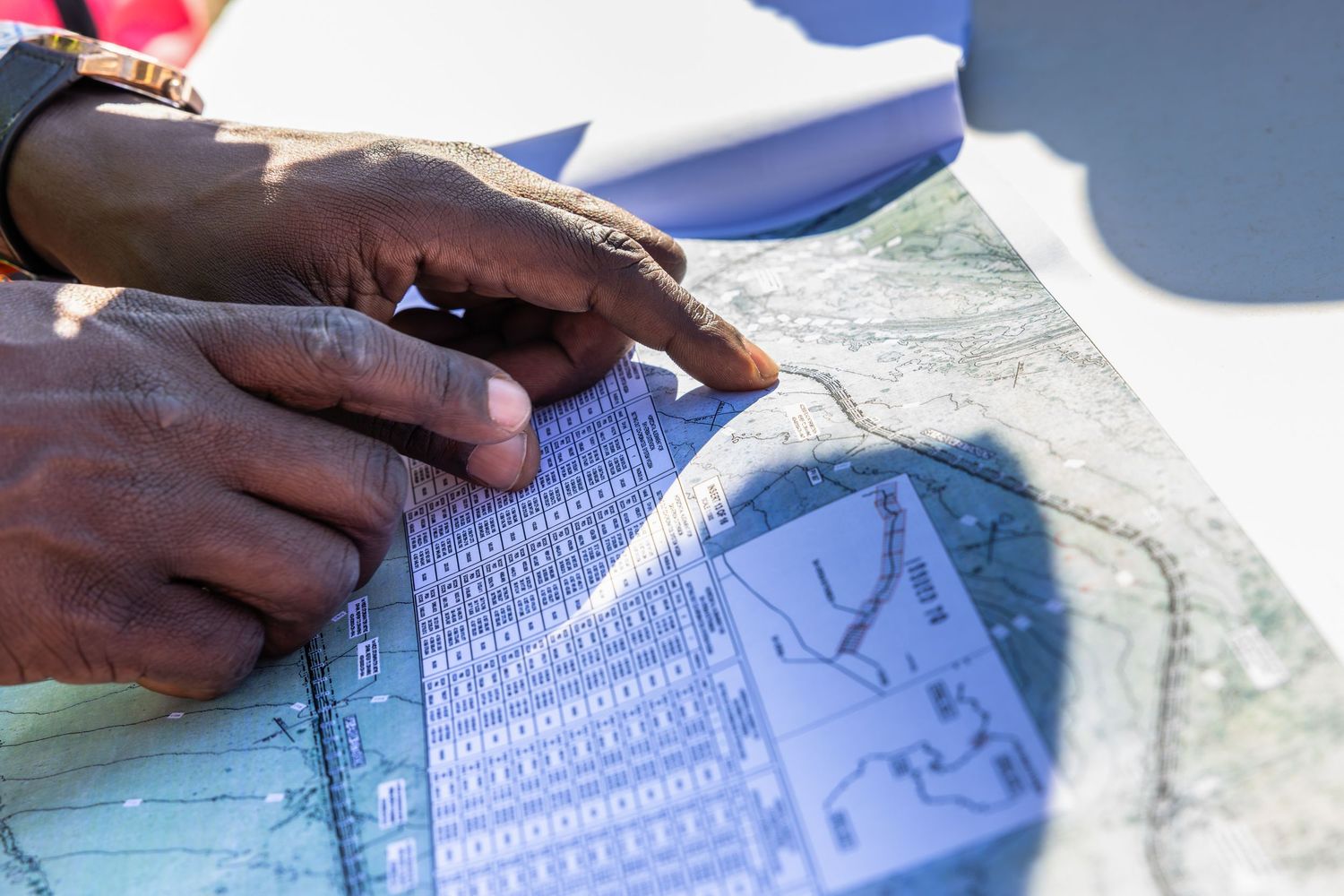 Close-up of hands reviewing technical documentation and blueprints.