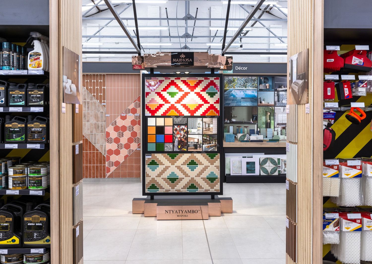 Wide view of retail space showing various bathroom product displays and geometric patterns.
