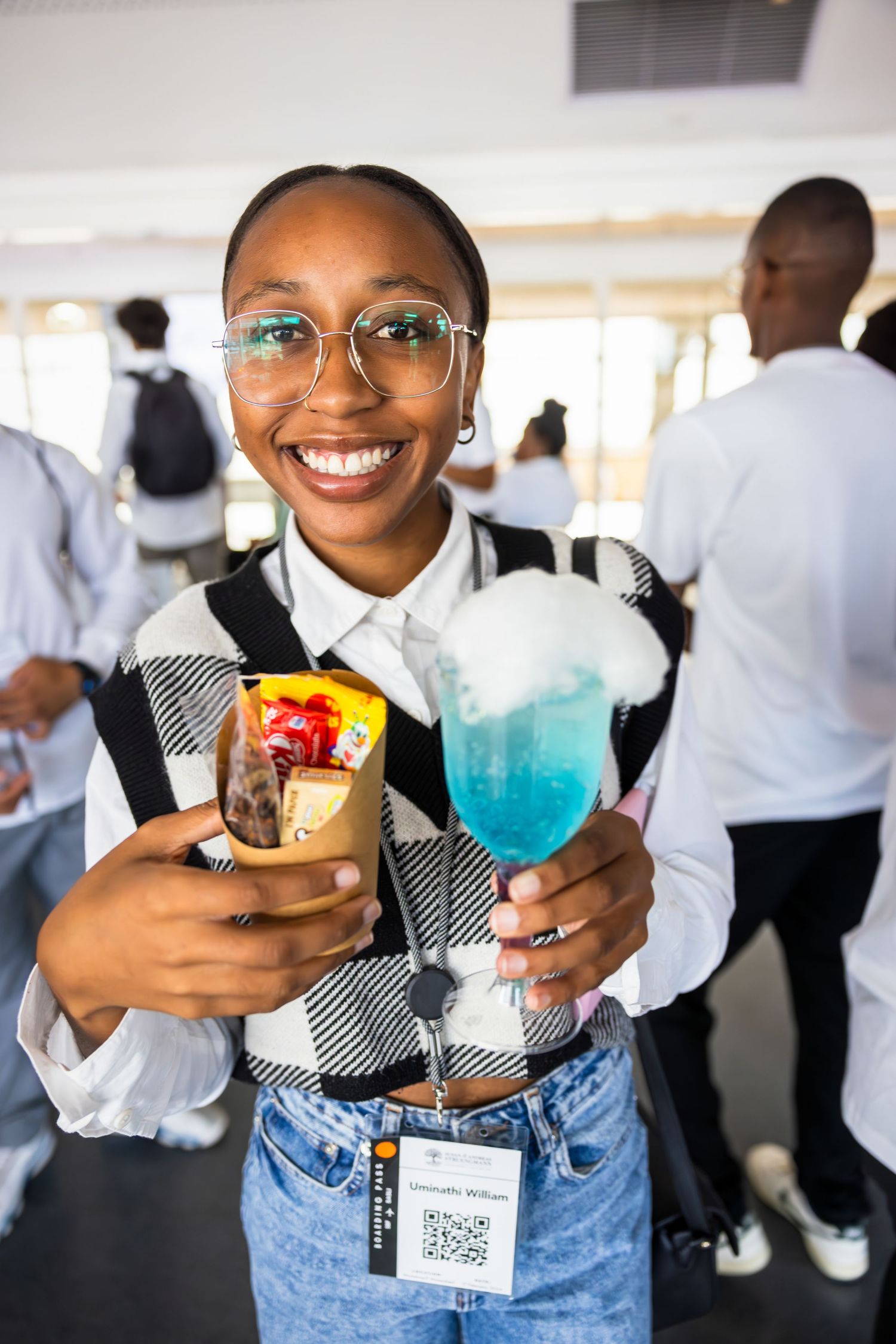 Conference attendees holding colorful drinks during a social networking event.