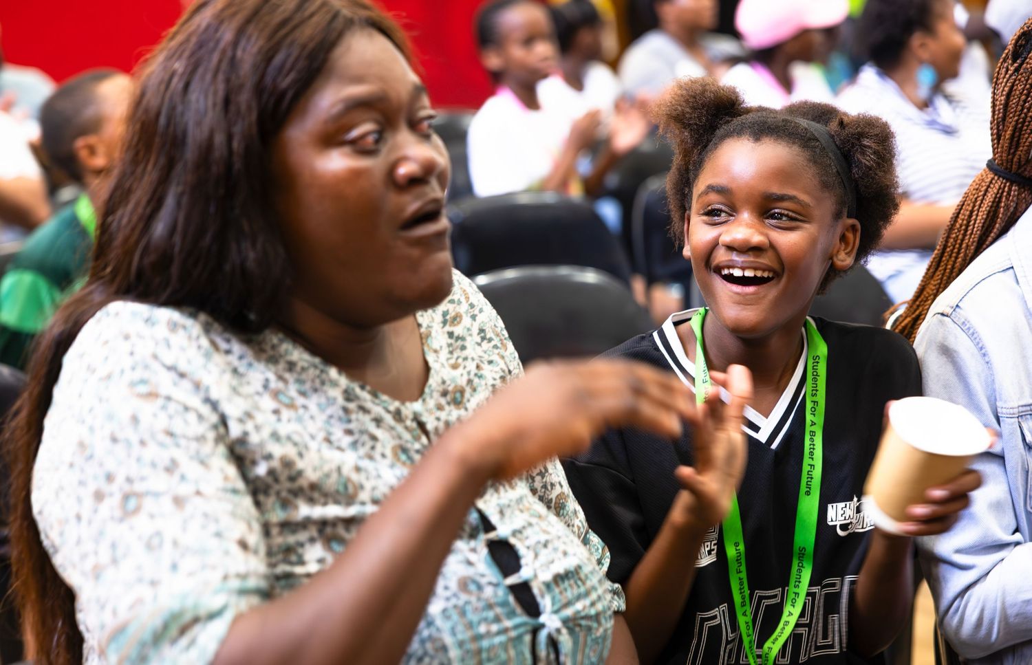 Students celebrating and laughing together in a joyful classroom moment.
